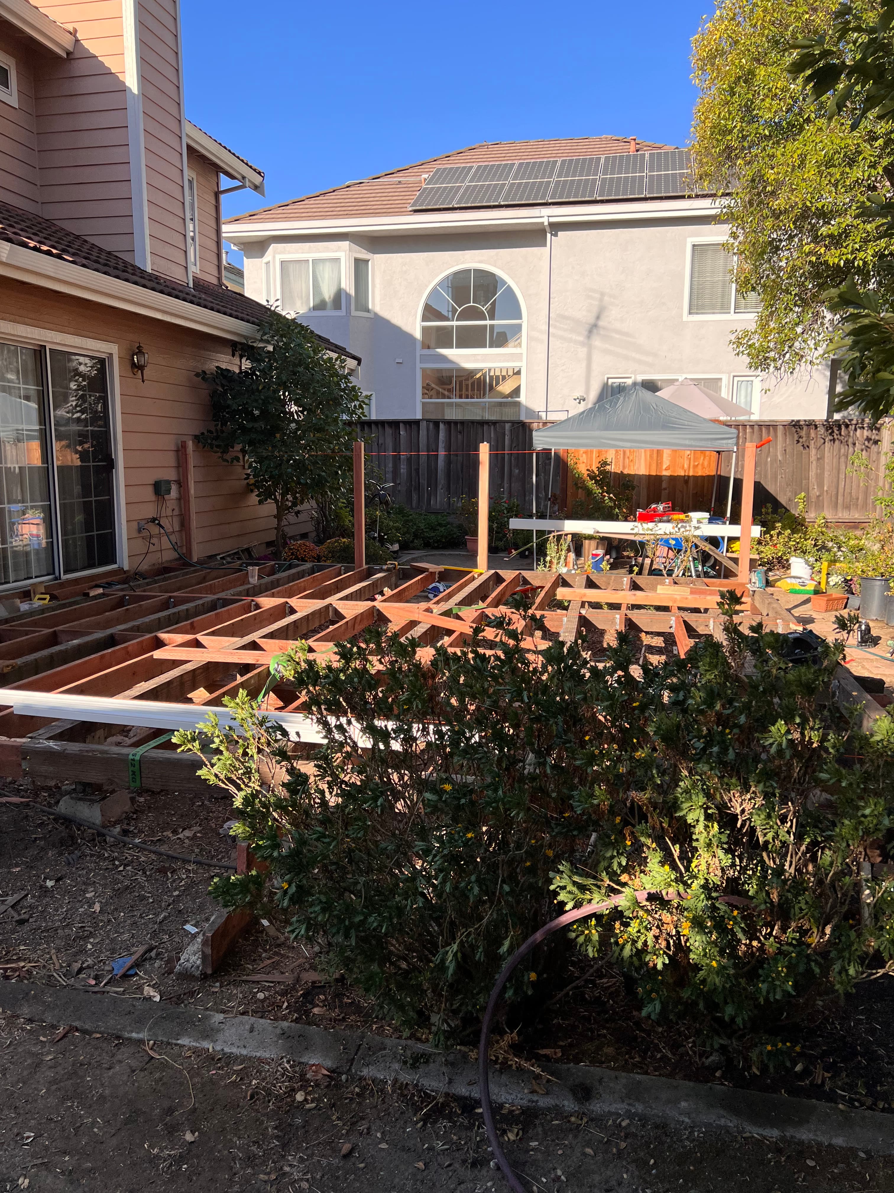 Redwood deck with pergola structure being built by Far West Builders Bay Area contractors