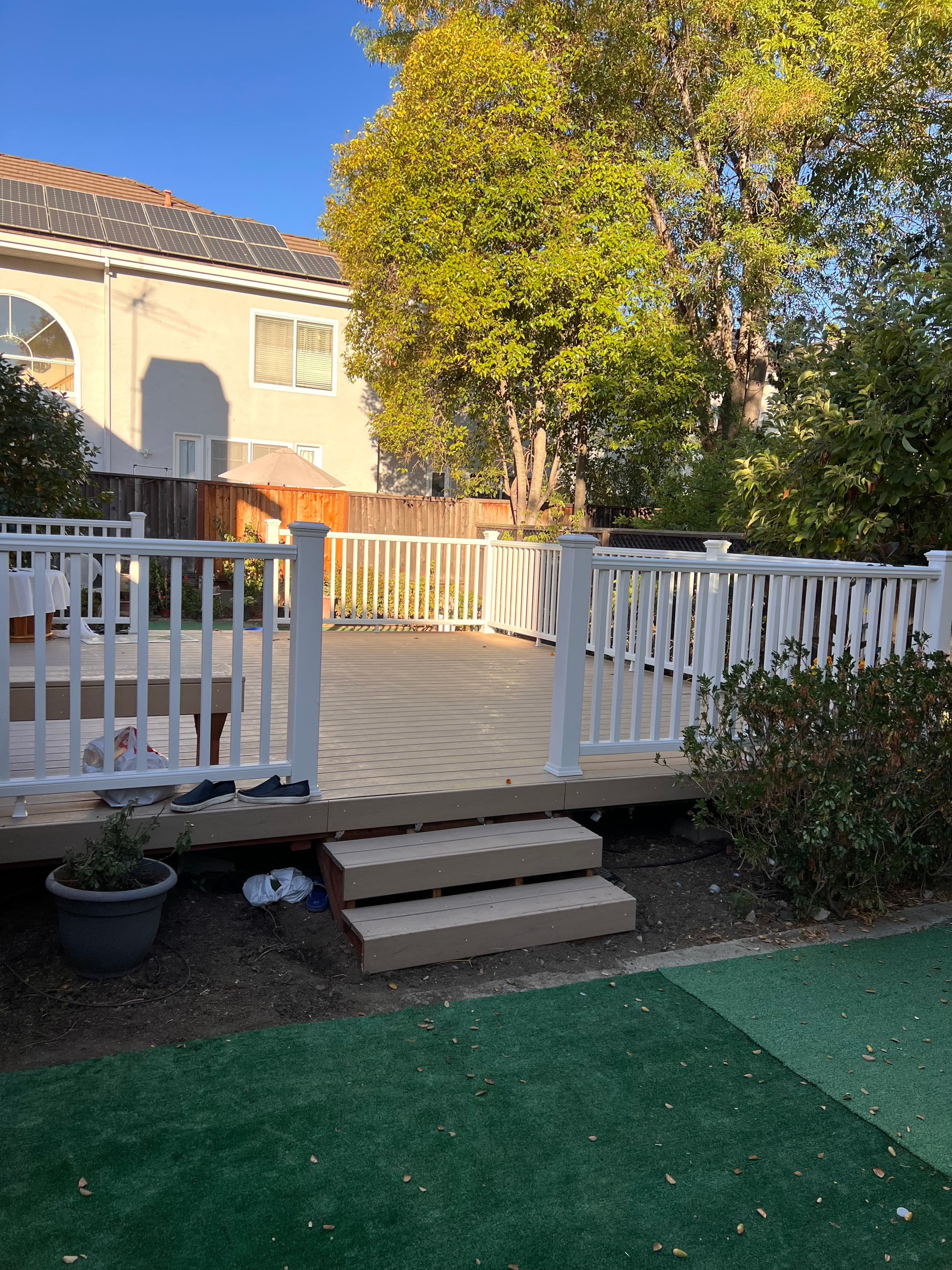 Completed composite deck with white vinyl railing installed by Far West Builders in SF Bay Area