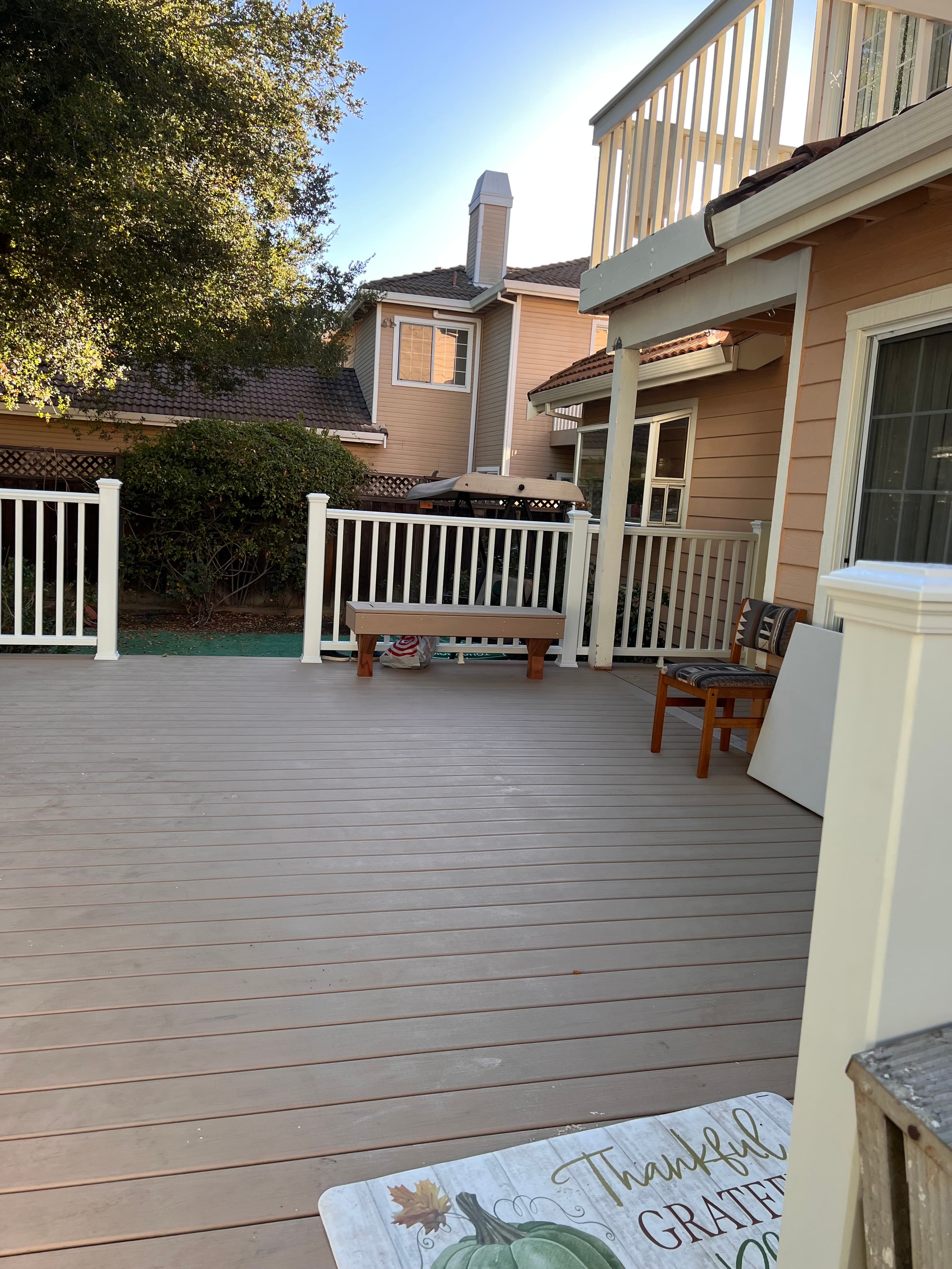 Composite deck with white railing and gate built by Far West Builders Bay Area general contractor