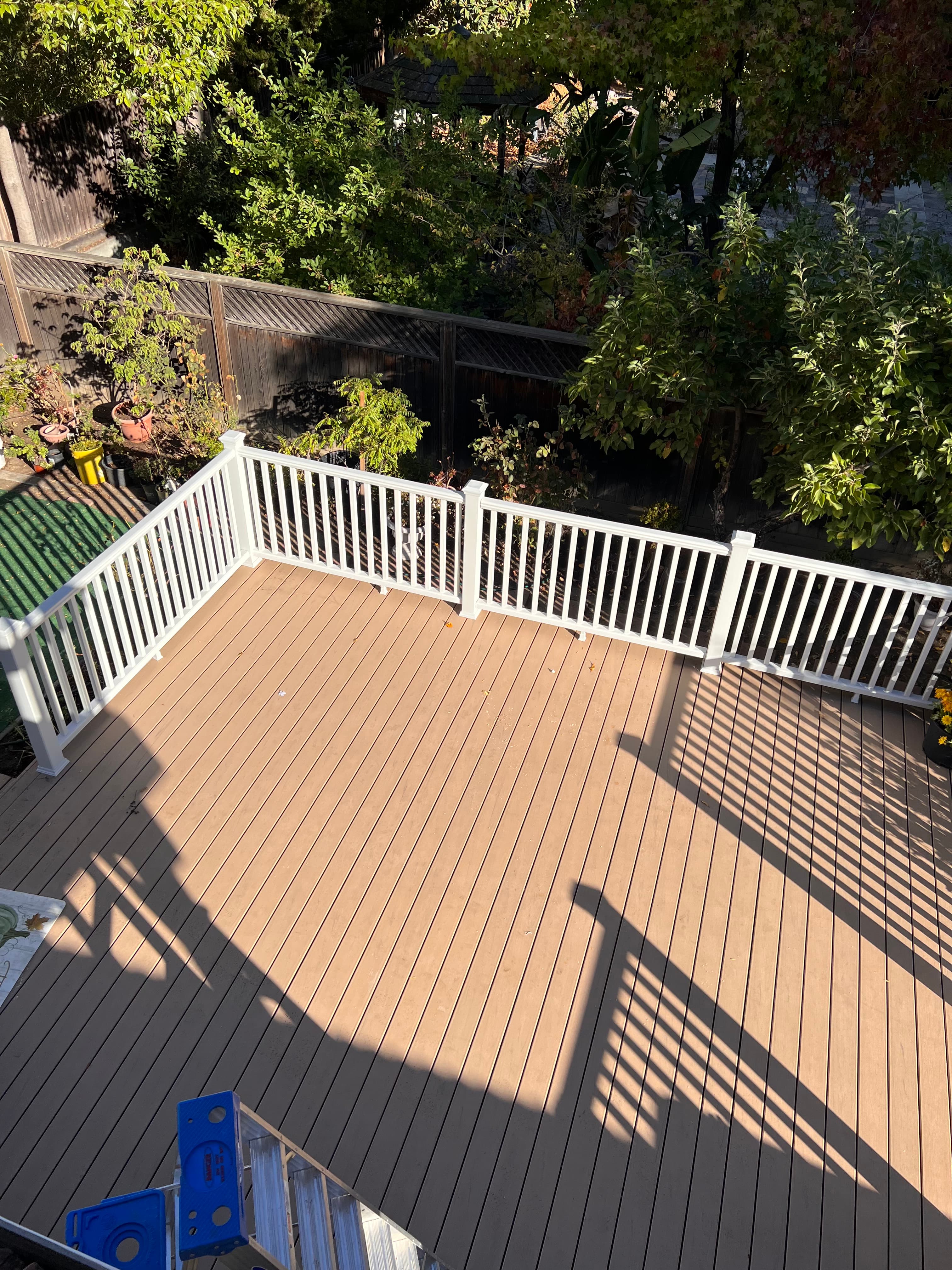 Overhead view of composite deck with white corner railing by Far West Builders SF Bay Area