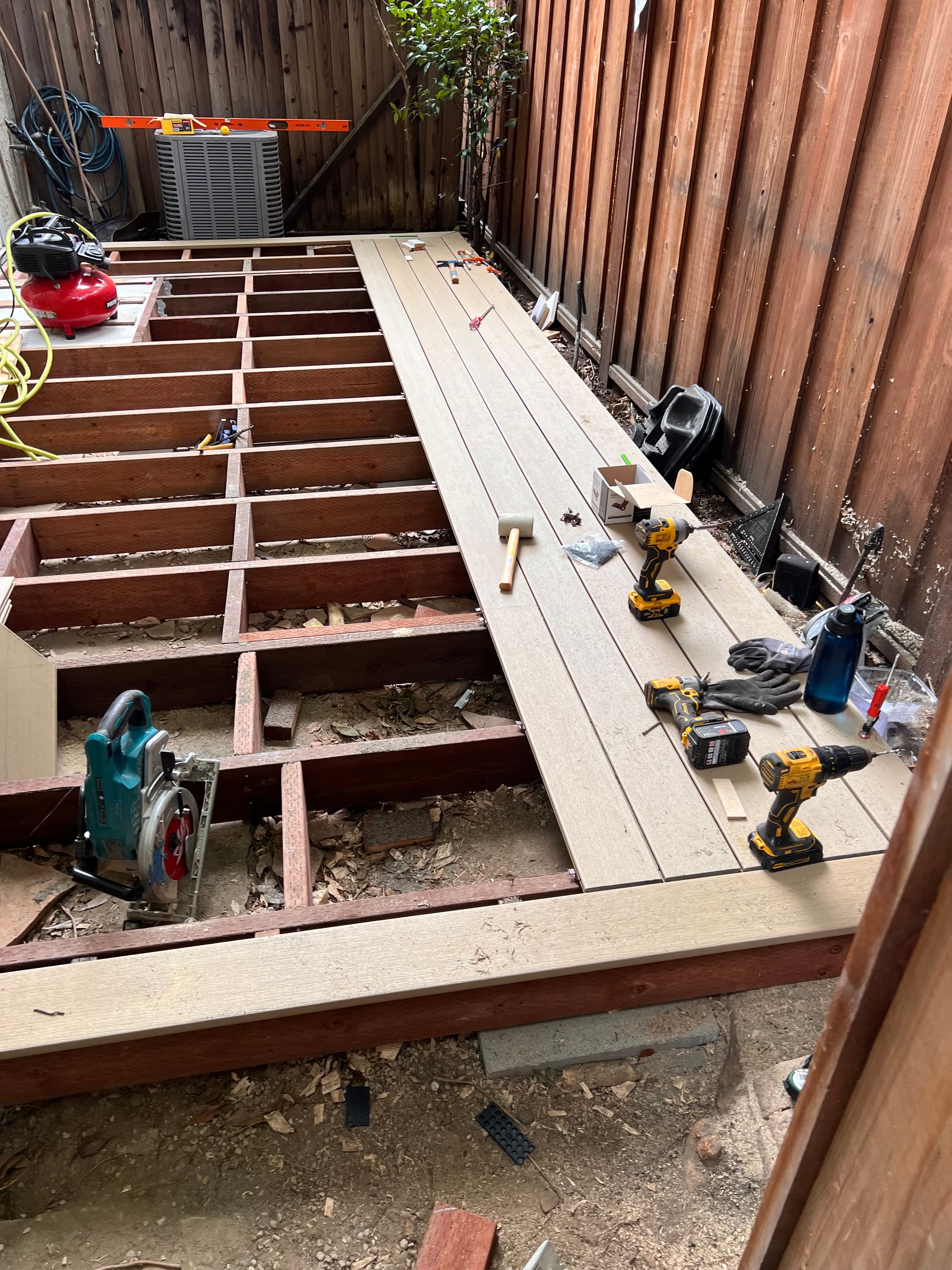Deck substructure framing and board installation in progress by Far West Builders Bay Area